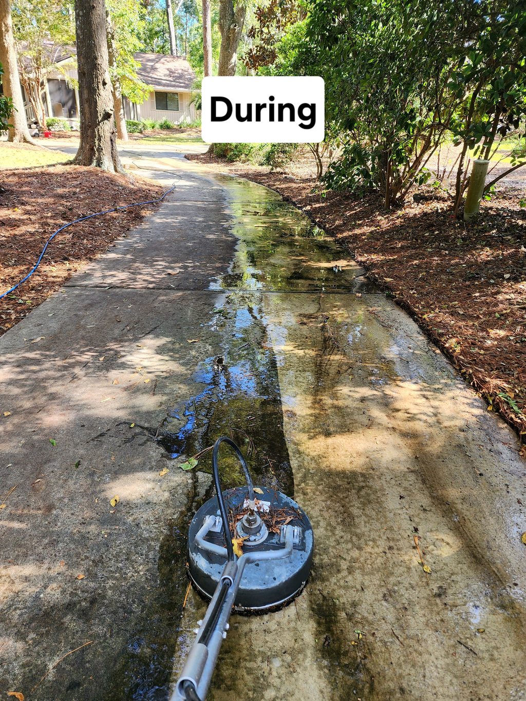 Surface cleaner lifting grime from a concrete driveway in Hilton Head, SC