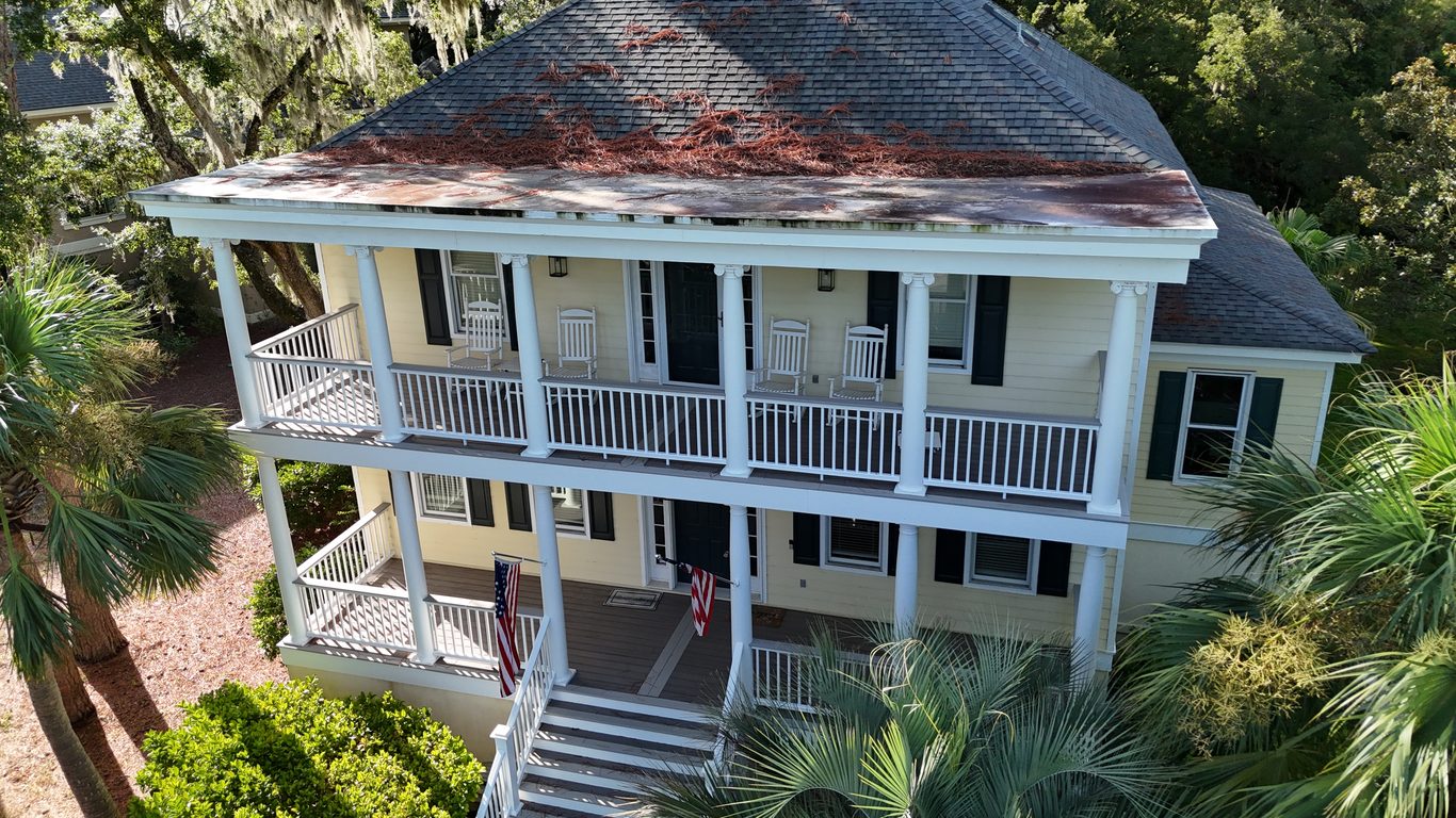 Roof covered in pine straw and debris before cleaning, aerial view in the Lowcountry