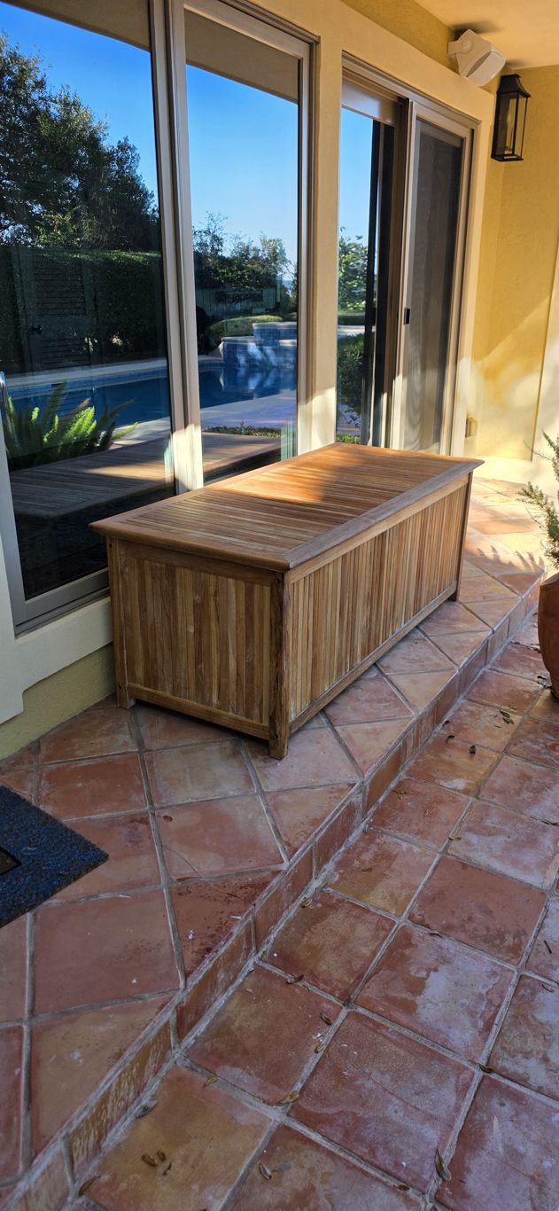 Terracotta tile patio and teak storage box after cleaning in Hilton Head, SC