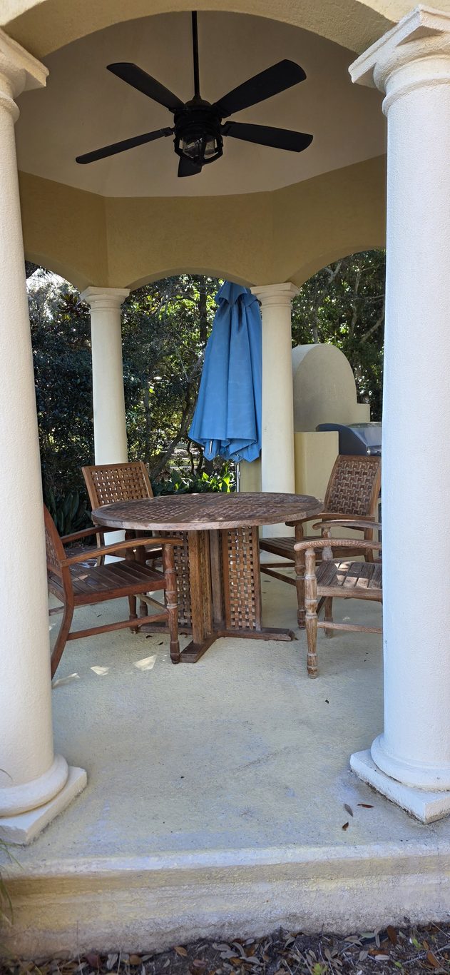 Cleaned teak dining set in a poolside gazebo in Hilton Head, SC