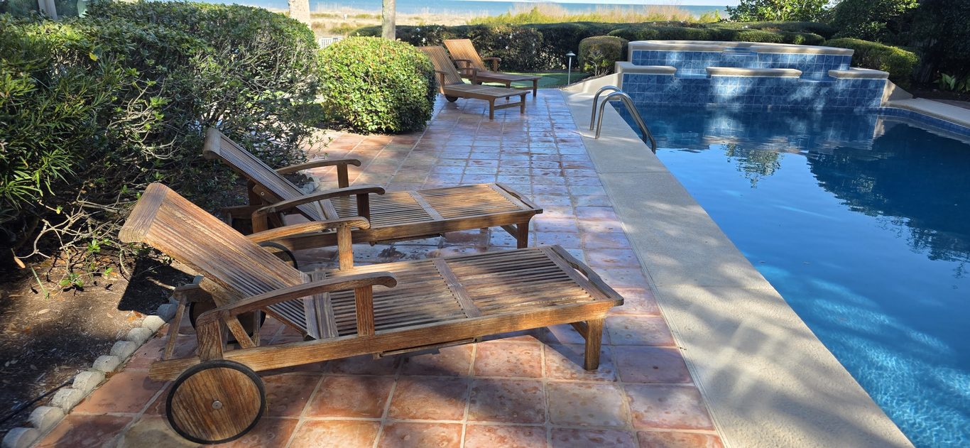 Restored teak loungers on a clean pool deck in Hilton Head, SC